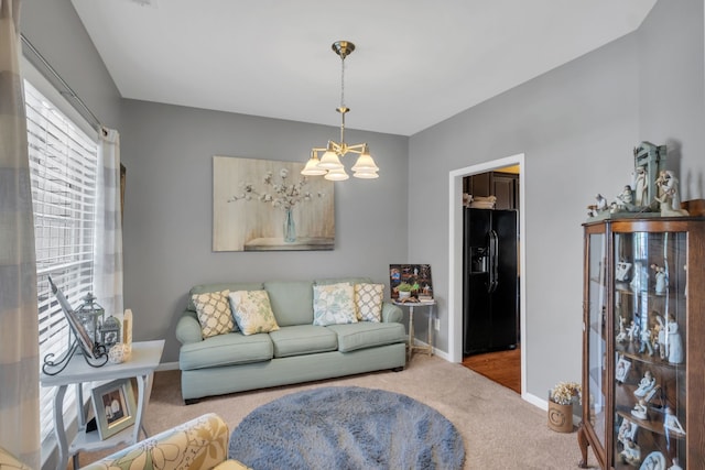 carpeted living room with a notable chandelier