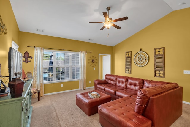 carpeted living room with ceiling fan and vaulted ceiling