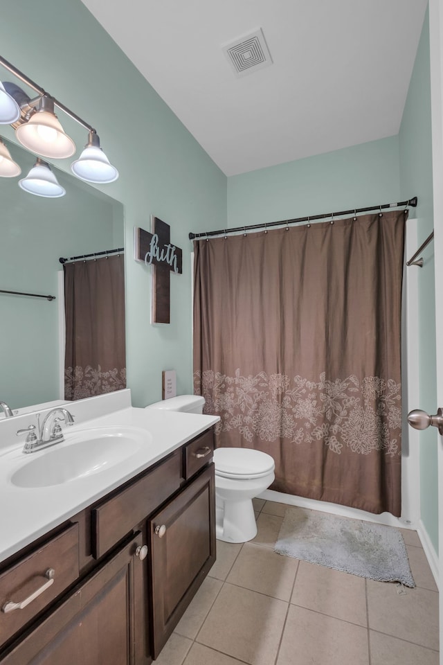 bathroom featuring toilet, vanity, and tile patterned floors