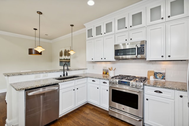 kitchen featuring sink, hanging light fixtures, stainless steel appliances, dark hardwood / wood-style flooring, and white cabinets