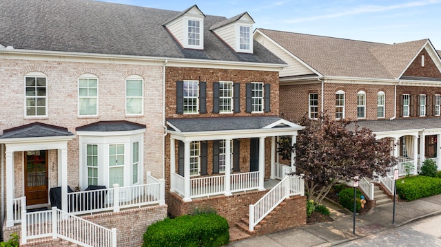 townhome / multi-family property featuring covered porch