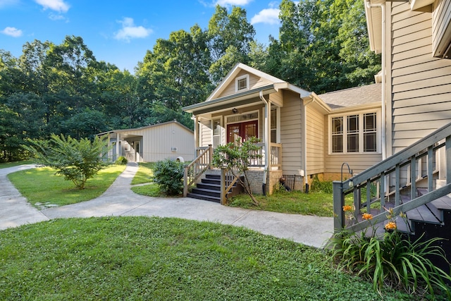 view of front of property with covered porch and a front yard