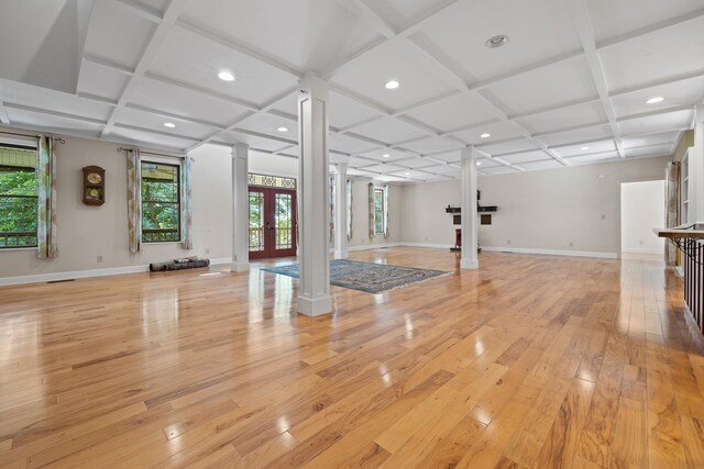 workout room with baseboards, coffered ceiling, decorative columns, and light wood-style floors