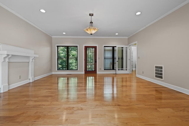 unfurnished living room featuring recessed lighting, crown molding, light wood-style flooring, and baseboards