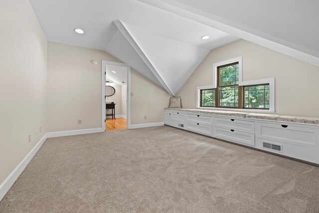 additional living space featuring lofted ceiling, recessed lighting, light colored carpet, visible vents, and baseboards