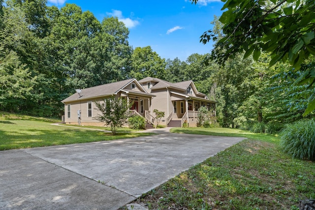 view of front facade featuring covered porch, driveway, a front lawn, and crawl space