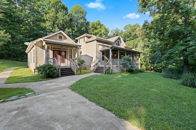 bungalow-style house featuring a porch, a front lawn, and aphalt driveway