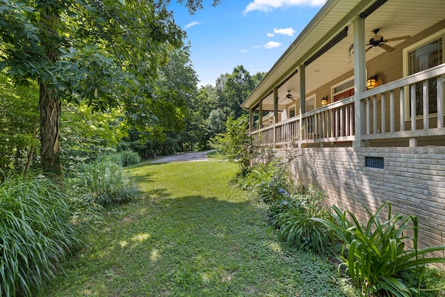 view of yard featuring ceiling fan and a porch