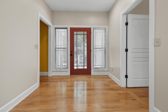 entryway with light wood-style flooring and baseboards