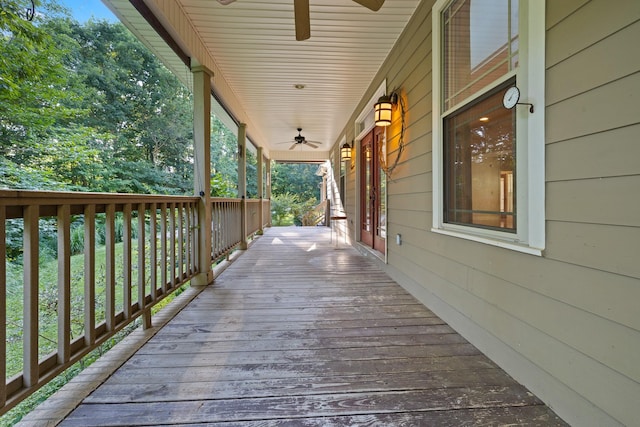 wooden deck with a porch and a ceiling fan