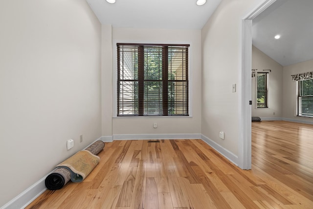 unfurnished room with light wood-type flooring, baseboards, vaulted ceiling, and recessed lighting