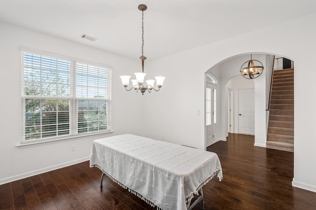 dining space with a chandelier and dark hardwood / wood-style flooring