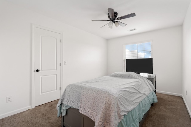 bedroom with ceiling fan and dark carpet