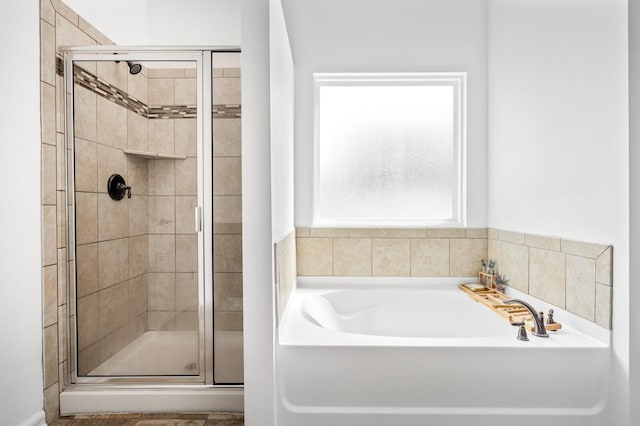 bathroom featuring separate shower and tub