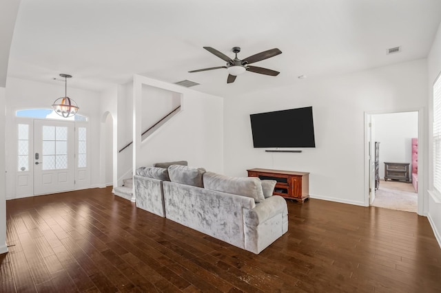 living room featuring ceiling fan and dark hardwood / wood-style flooring