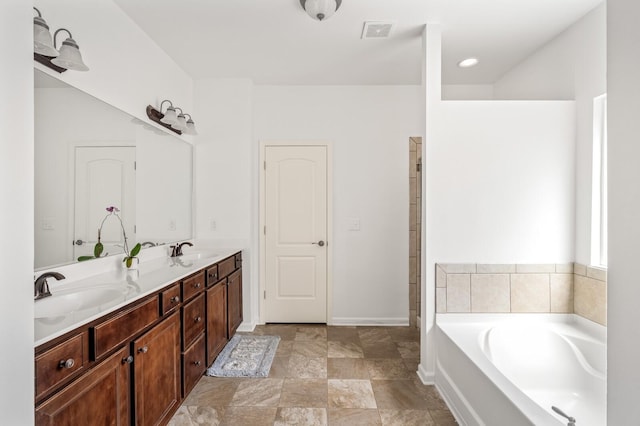 bathroom featuring vanity and a bath