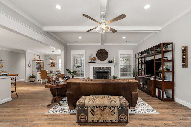 living room with beamed ceiling, ceiling fan, crown molding, and hardwood / wood-style flooring