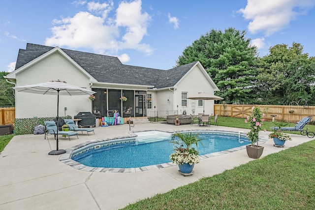 view of pool featuring a patio area, grilling area, and a lawn