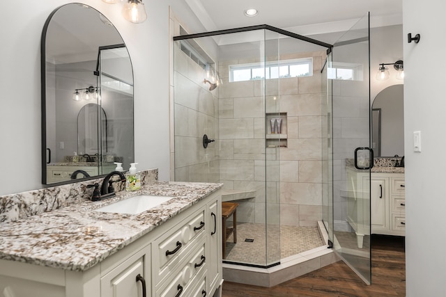 bathroom featuring vanity, walk in shower, and hardwood / wood-style floors