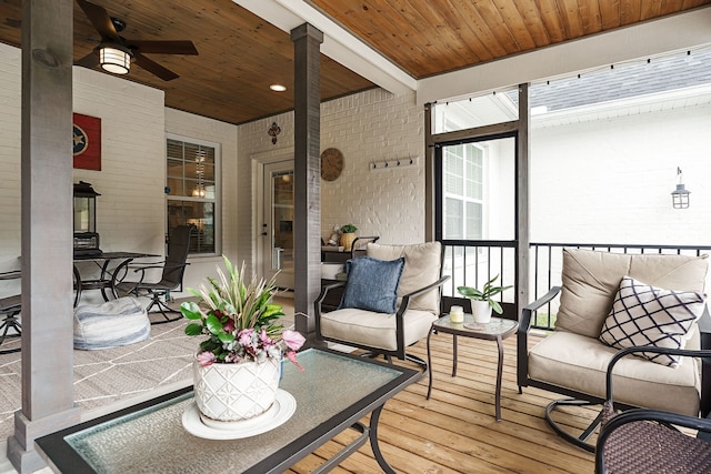 sunroom / solarium featuring ceiling fan and wood ceiling