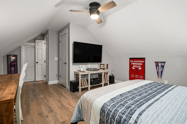 bedroom with ceiling fan, vaulted ceiling, and hardwood / wood-style floors