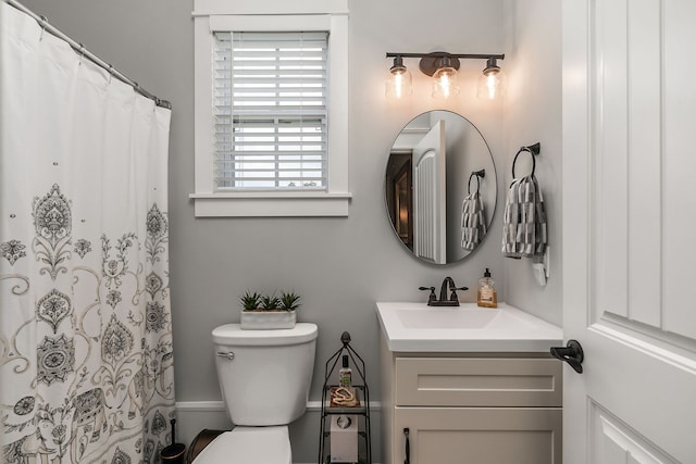 bathroom with toilet, a shower with shower curtain, and vanity