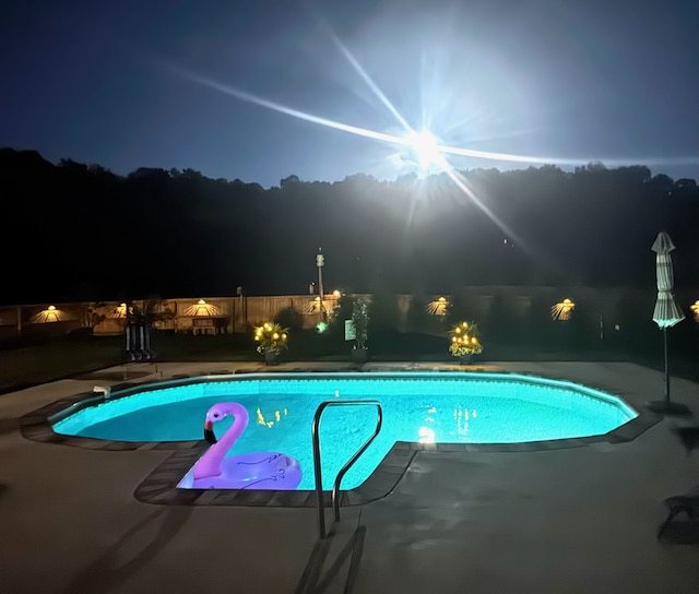 pool at night with a patio