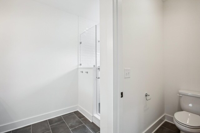 bathroom with tile patterned flooring and toilet