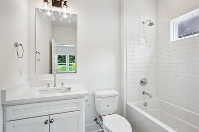 full bathroom with tiled shower / bath combo, toilet, and vanity