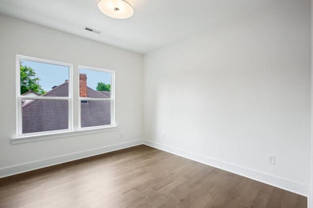 spare room with hardwood / wood-style floors