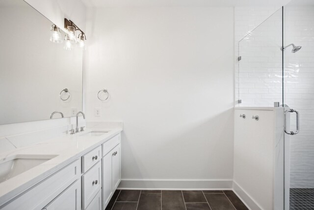 bathroom with a shower with door, tile patterned flooring, and vanity