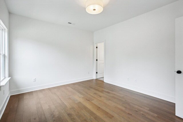 spare room featuring wood-type flooring