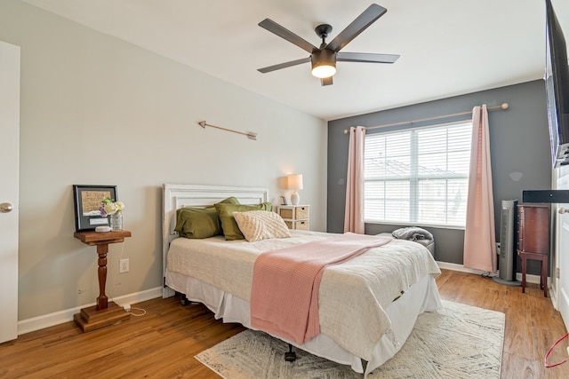 bedroom with ceiling fan and light hardwood / wood-style floors