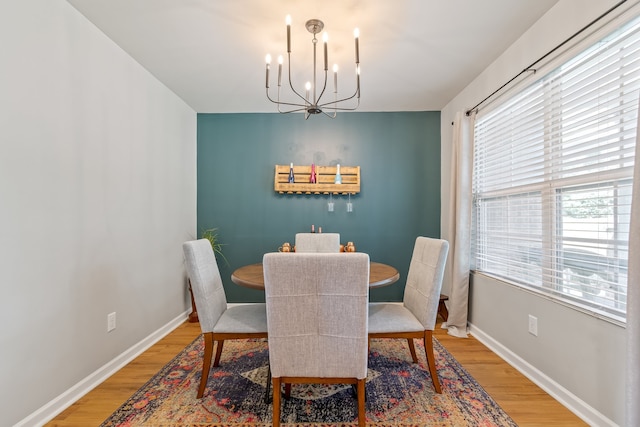 dining room with light hardwood / wood-style floors and a chandelier