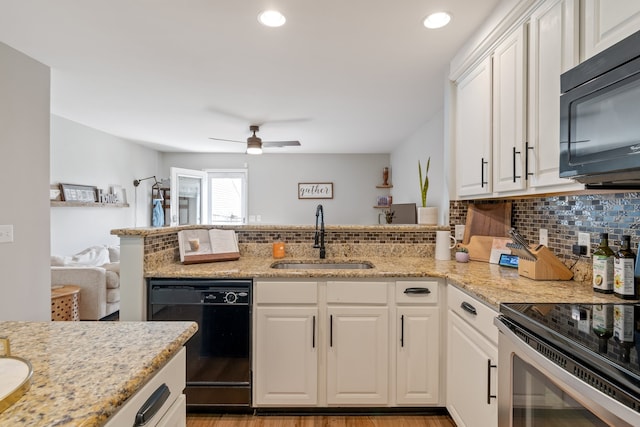 kitchen featuring ceiling fan, decorative backsplash, light wood-type flooring, sink, and black appliances