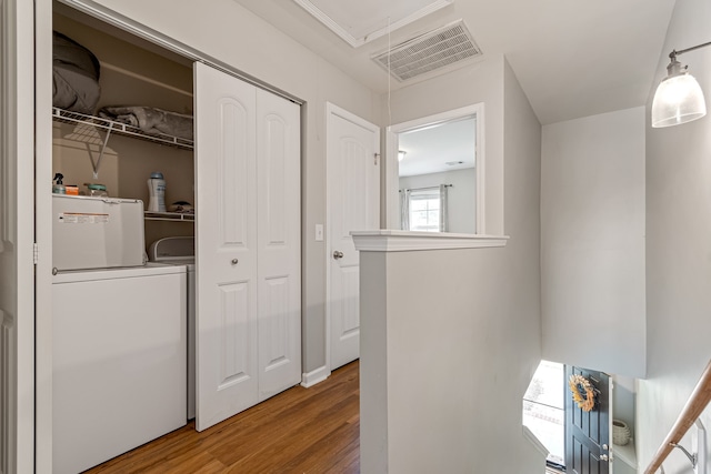 laundry area featuring hardwood / wood-style floors and separate washer and dryer