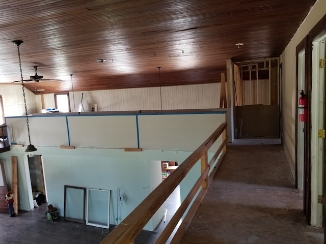 interior space with ceiling fan and wood ceiling