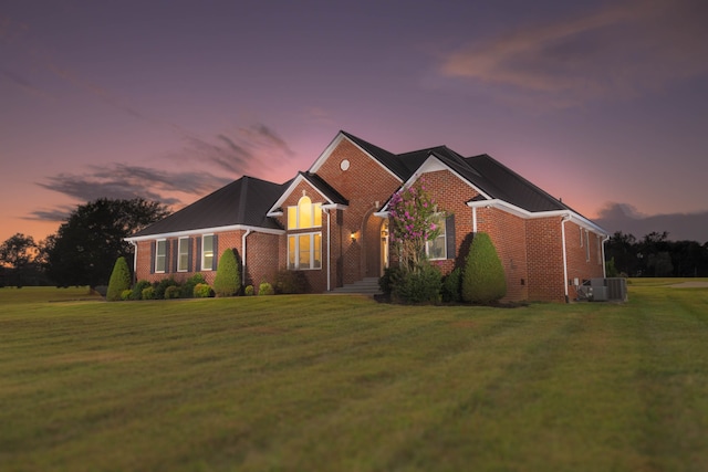 view of front of house with a lawn and cooling unit