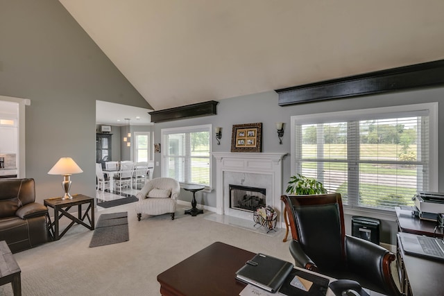 interior space featuring carpet flooring, high vaulted ceiling, a high end fireplace, and a healthy amount of sunlight