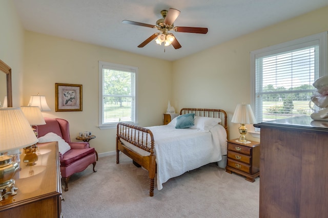 bedroom featuring light colored carpet and ceiling fan