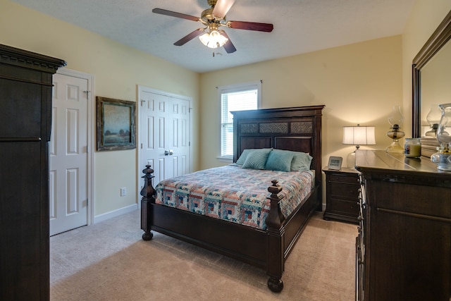 bedroom with ceiling fan and light carpet