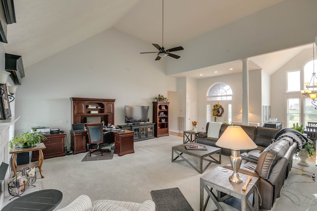 carpeted living room with ceiling fan and high vaulted ceiling