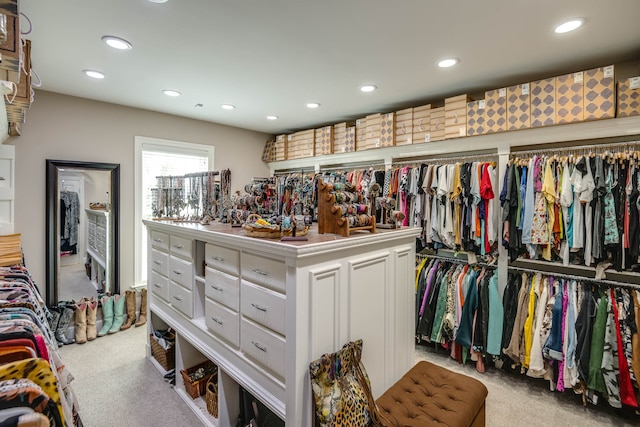 walk in closet featuring light carpet