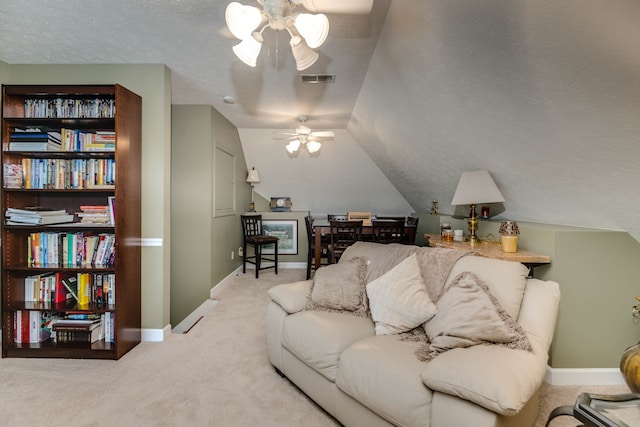 carpeted living room with a textured ceiling, ceiling fan, and lofted ceiling