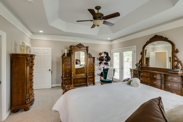 bedroom featuring ceiling fan, access to outside, light carpet, a tray ceiling, and ornamental molding