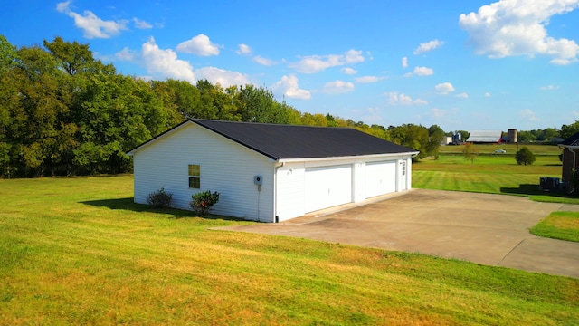 garage featuring a yard and solar panels