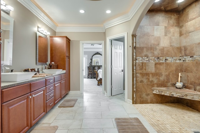 bathroom with tile patterned flooring, crown molding, vanity, and tiled shower