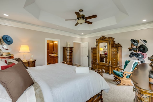 bedroom with carpet floors, ceiling fan, a raised ceiling, and ensuite bathroom