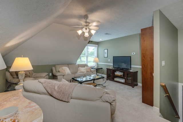 living room with a textured ceiling, ceiling fan, light carpet, and lofted ceiling