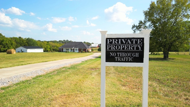 community / neighborhood sign with a lawn